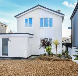 A house with gravel driveway and plants at Penrhos Walks Holyhead