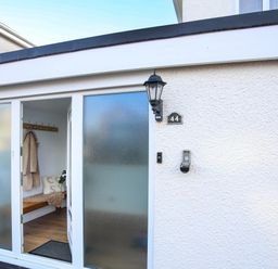 An entrance with a door and coat hooks at Penrhos Walks Holyhead
