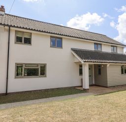 A house with windows and a door at Holly Farm near Brantham