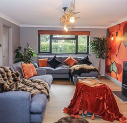 A living room with a sofa and a table at Holly Farm near Brantham