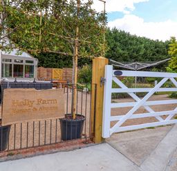 An outdoor view featuring a gate and sign at Holly Farm near Brantham