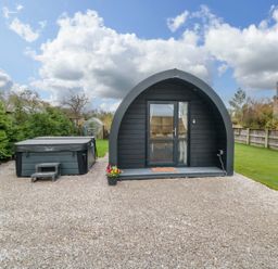 An outdoor view of a glamping pod and jacuzzi at Bumblebee Glamping Pod Malton