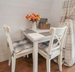 A dining area with a table and chairs at Bumblebee Glamping Pod in Malton