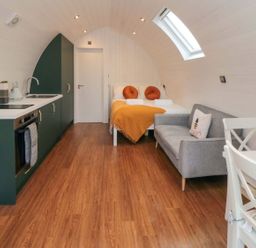 A pod with kitchen units and bed at Bumblebee Glamping Pod in Malton