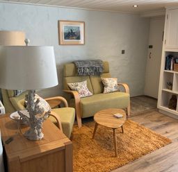 A living room with a sofa and coffee table at Tamarisk Cottage in St Agnes