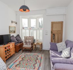 A living room with a sofa and armchair at 1 Castle Terrace