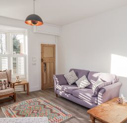 A living room with a sofa and armchair at 1 Castle Terrace