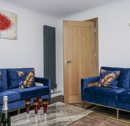 A living room with blue sofas and a table at Aspen Boutique in 