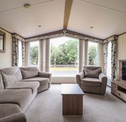 A living room with a sofa and coffee table at Beach Retreat E19 Dyffryn Seaside Estate Dyffryn Ardudwy