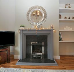 A living room with a fireplace and television at Gavin and Stacey House in Barry