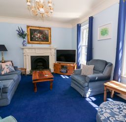A living room with sofa and television at Ty Caredig in Swansea