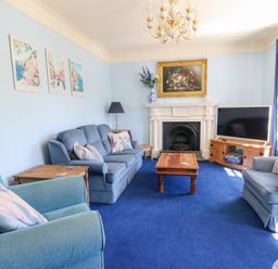 A living room with sofas and a coffee table at Ty Caredig in Swansea