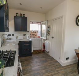 A kitchen with a sink and stove at 13 School Road Newton Abbot