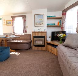 A living room with a sofa, coffee table, and television at 21 Poplar Avenue in Felixstowe, Suffolk