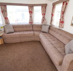 A living room with a sofa and a television at 21 Poplar Avenue in Felixstowe, Suffolk
