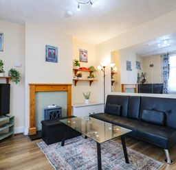 A living room with a sofa and coffee table at Dover Retreat