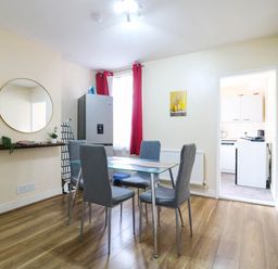 A dining room with a table and chairs at Dover Retreat