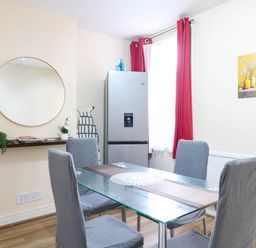 A dining room with a table and chairs at Dover Retreat