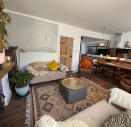 A living room with a sofa and coffee table at Bohemian Beach Cottage in Bournemouth