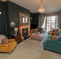 A living room with sofas and a fireplace at Stanton House - Abbey View, Flat 3