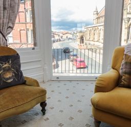 A living room with a view of the street and church at Stanton House - Abbey View, Flat 3 