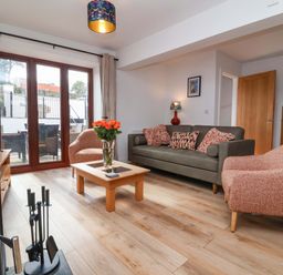 A living room with a sofa and coffee table at Butterfly Days in Bideford