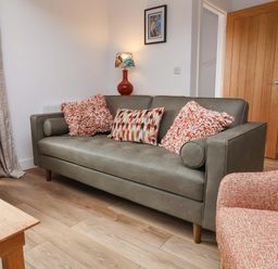 A living room with a sofa and chair at Butterfly Days in Bideford