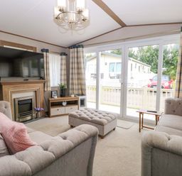 A living room with a television and sofa at 17 Castle Walk in Great Yarmouth