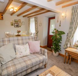 A living room with a sofa and table at Brondderwen in Blaenau Ffestiniog