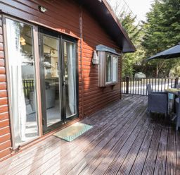 An outdoor space with a table and chairs at Springtime Lodge in Rhyd-y-Foel near Abergele