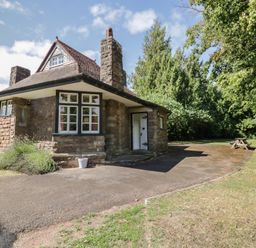 A house with a front door and windows at Raglan Lodge in Monmouth