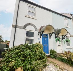 A house with a blue front door and pathway at 23 The Maltings in Weymouth