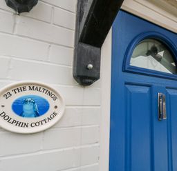 An entrance with a blue door and a nameplate at 23 The Maltings in Weymouth