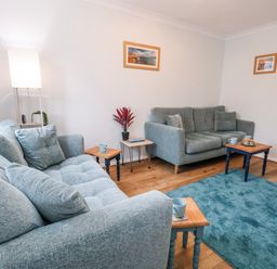 A living room with sofas and a side table at 23 The Maltings in Weymouth