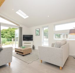 A living room with a sofa and television at 3 Meadow Retreat in Liskeard