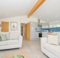 A living room with a sofa and kitchen in 3 Meadow Retreat Liskeard