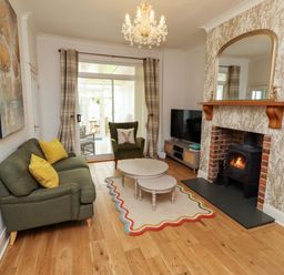 A living room with a sofa and coffee table at Rose Briar Cottage Morpeth