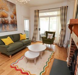 A living room with a sofa and coffee table at Rose Briar Cottage in Morpeth