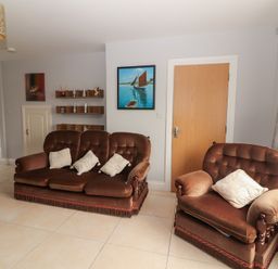 A living room with a sofa and armchairs at 1 Windermere in Kinvarra