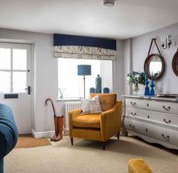 A living room featuring a yellow chair and a window at Lavender Cottage (Stow-on-the-Wold) Cheltenham
