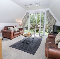 A living room with sofas and a coffee table at Valley Lodge 20 in Callington