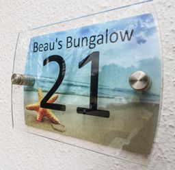 A nameplate displaying Beau's Bungalow 21 with a starfish at Manorcombe 21 Honicombe Holiday Village near Gunnislake