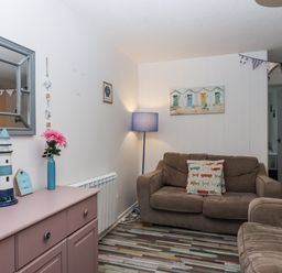 A living room with a sofa and decorative objects at Manorcombe 21 Honicombe Holiday Village near Gunnislake
