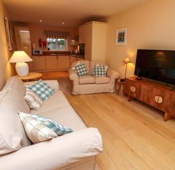 A living room with a sofa and television at High Sea View