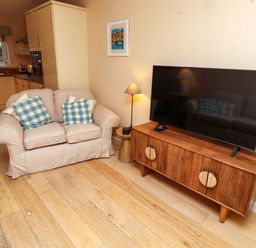 A living room with a sofa and television at High Sea View