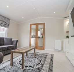 A living room with a sofa and coffee table at The Cabin in Thornton Dale