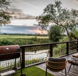 An outdoor area with a barbecue grill and chairs at The Red House in Farndon