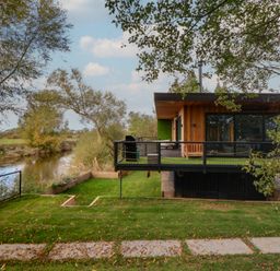 A house with a balcony overlooking a river at The Red House in Farndon