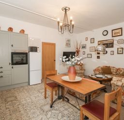 A kitchen with a dining table and chairs at Apartment 1 The Bridge at Stanford Hotel near Great Witley