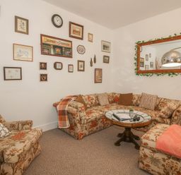 A living room with a sofa and armchair at Apartment 1 The Bridge at Stanford Hotel near Great Witley